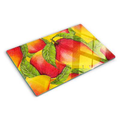 Chopping board glass Peppers on a background of green leaves