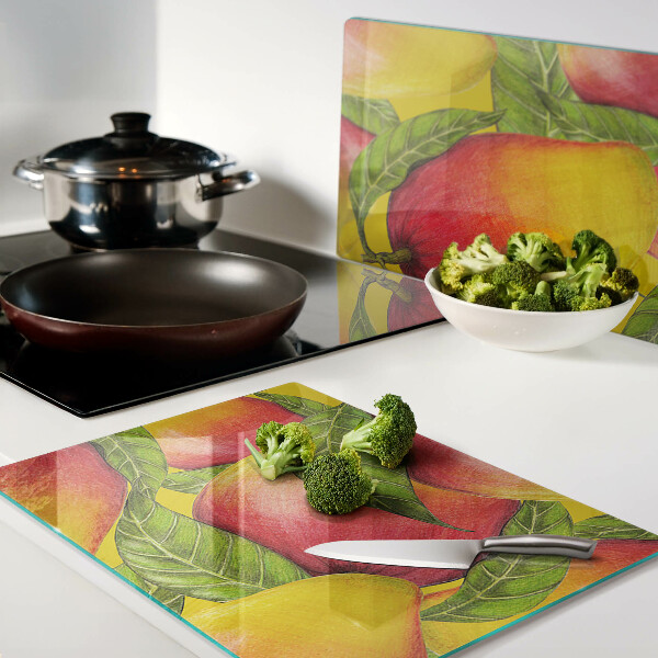Chopping board glass Peppers on a background of green leaves