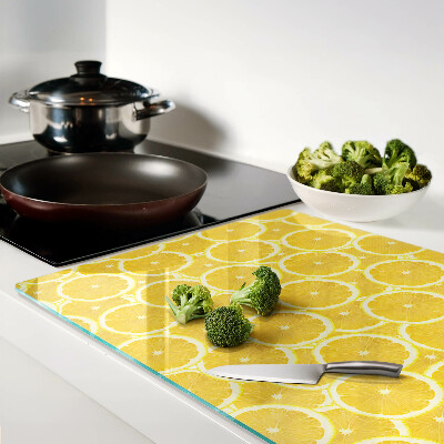 Glass kitchen board Lemon slices on a yellow background