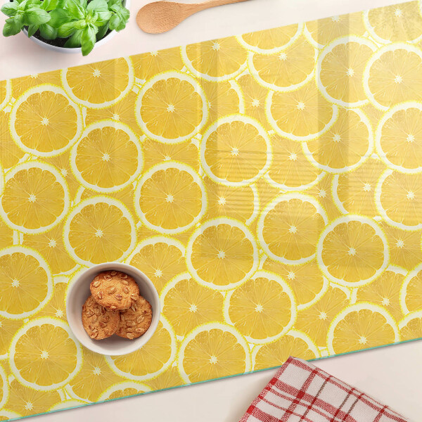 Glass kitchen board Lemon slices on a yellow background
