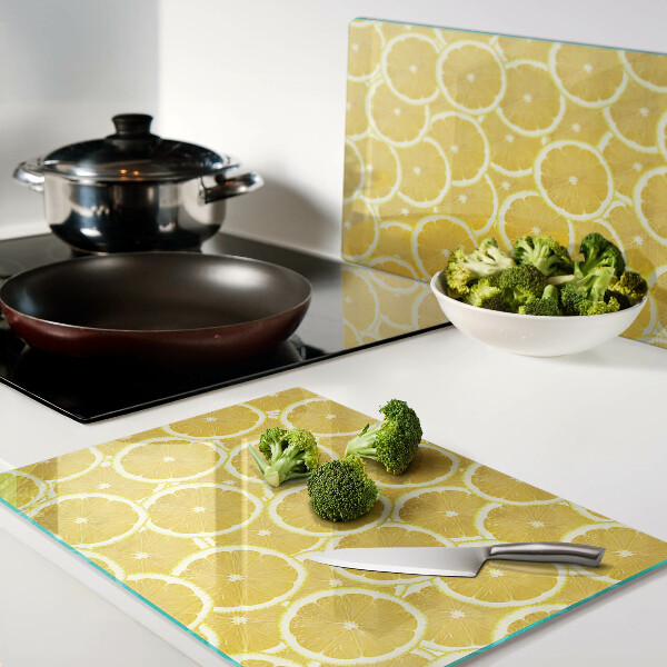 Glass kitchen board Lemon slices on a yellow background