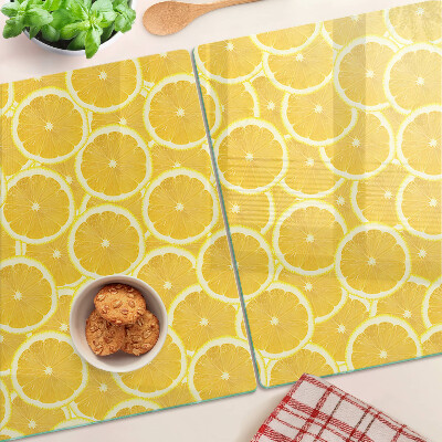 Glass kitchen board Lemon slices on a yellow background