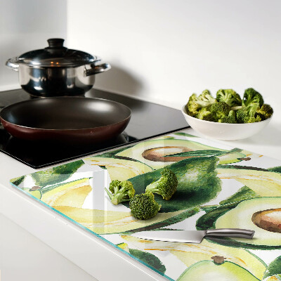 Glass cutting board Avocado with leaves in the background