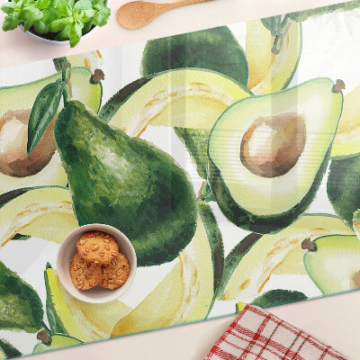 Glass cutting board Avocado with leaves in the background
