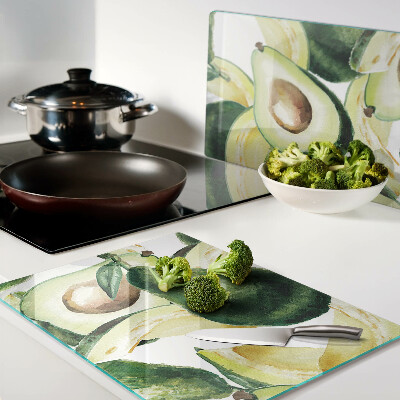 Glass cutting board Avocado with leaves in the background