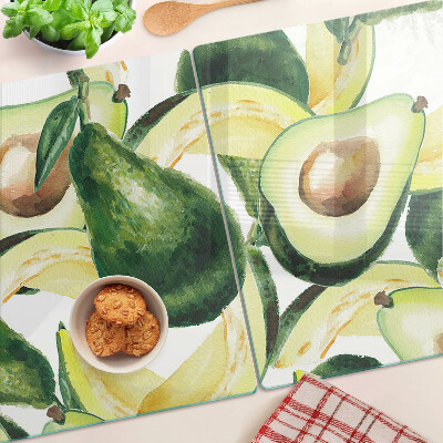 Glass cutting board Avocado with leaves in the background
