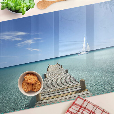 Glass kitchen board Pier over the turquoise sea
