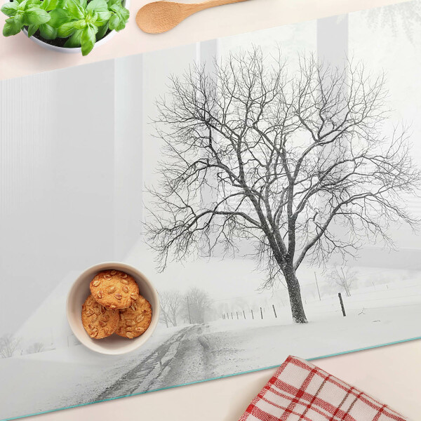 Glass kitchen board Empty winter landscape with a tree