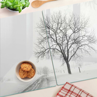 Glass kitchen board Empty winter landscape with a tree