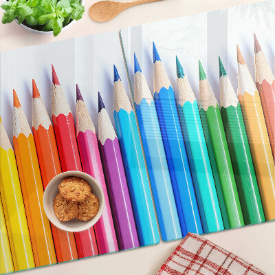 Chopping board Colored pencils in a row