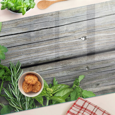 Chopping board glass Green herbs on a wooden background