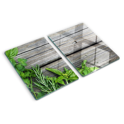 Chopping board glass Green herbs on a wooden background