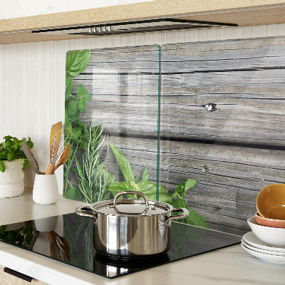 Chopping board glass Green herbs on a wooden background