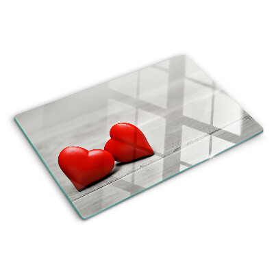 Cutting board Red hearts on a wooden background
