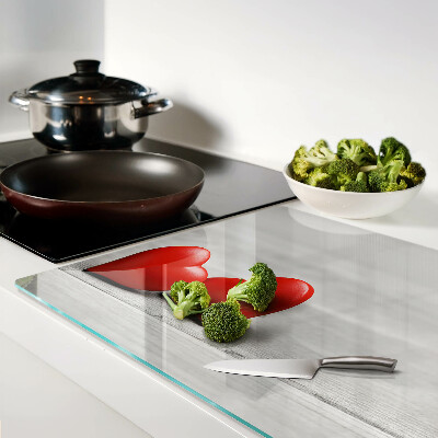 Cutting board Red hearts on a wooden background