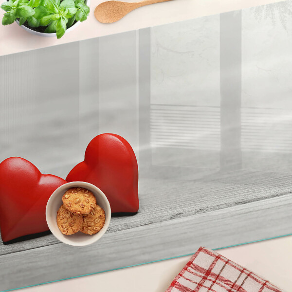 Cutting board Red hearts on a wooden background