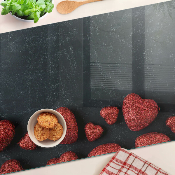 Glass chopping board Red hearts on a dark background