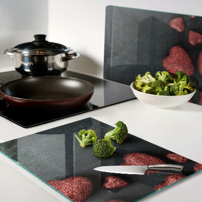 Glass chopping board Red hearts on a dark background