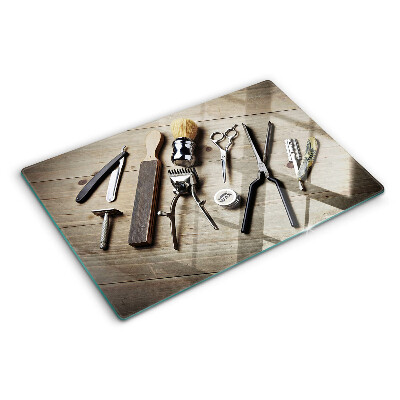 Glass cutting board Hairdressing tools on a wooden background