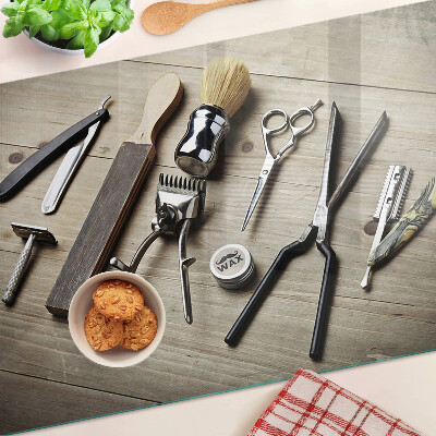 Glass cutting board Hairdressing tools on a wooden background
