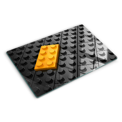 Chopping board glass LEGO bricks on a black background