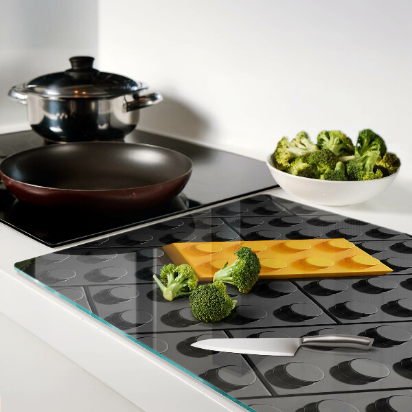 Chopping board glass LEGO bricks on a black background