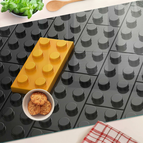 Chopping board glass LEGO bricks on a black background