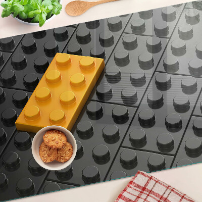 Chopping board glass LEGO bricks on a black background