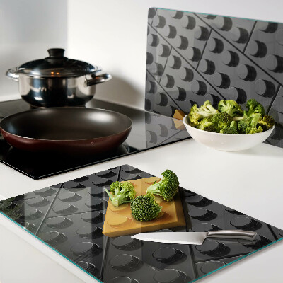 Chopping board glass LEGO bricks on a black background