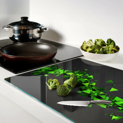 Glass kitchen board Green triangles on a black background