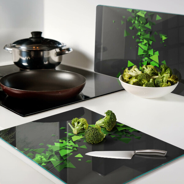 Glass kitchen board Green triangles on a black background
