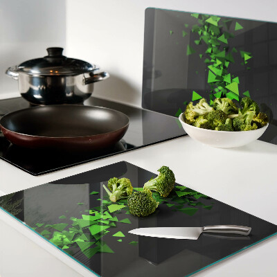 Glass kitchen board Green triangles on a black background