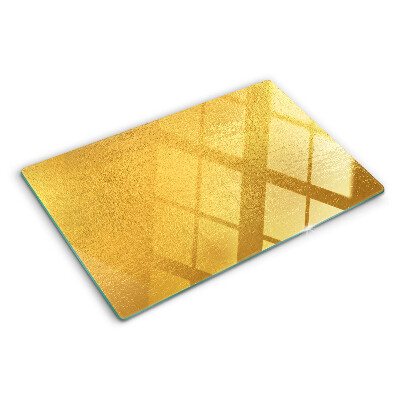 Chopping board glass Golden surface with reflections