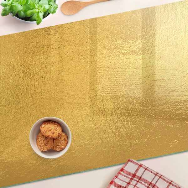 Chopping board glass Golden surface with reflections