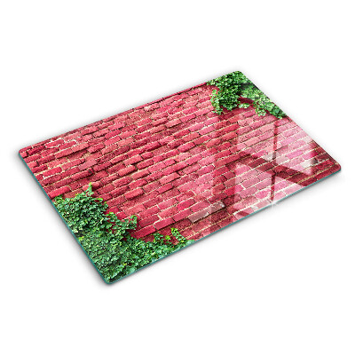 Glass chopping board Brick wall with vegetation