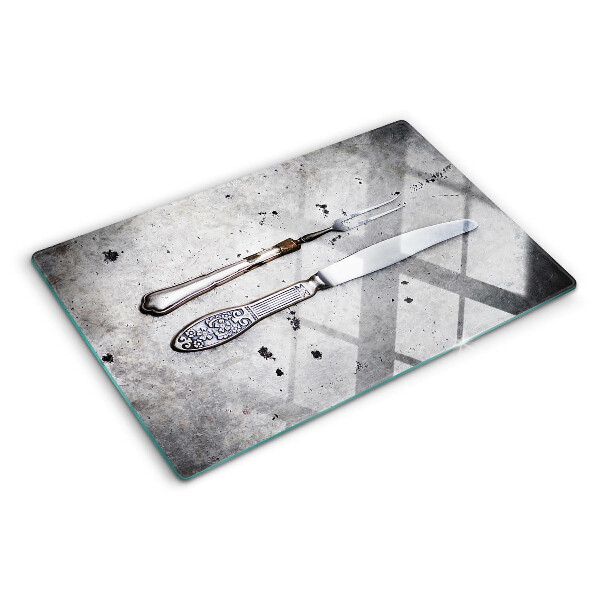 Glass kitchen board Cutlery on a concrete background