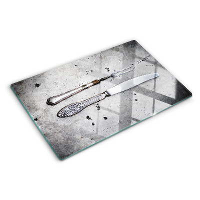 Glass kitchen board Cutlery on a concrete background