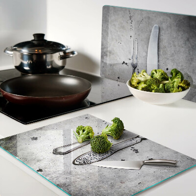 Glass kitchen board Cutlery on a concrete background