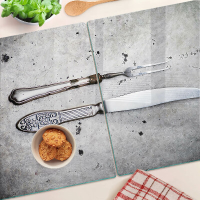 Glass kitchen board Cutlery on a concrete background