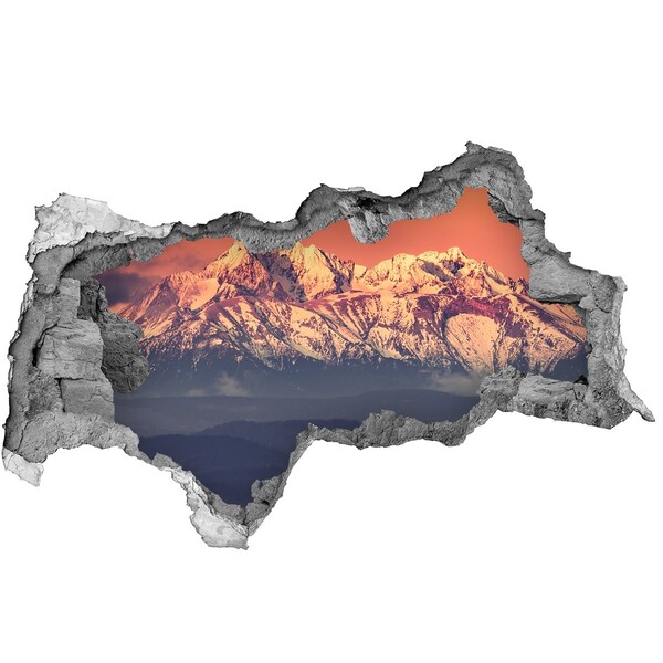 Hole in the wall sticker Mountains in the glow of sunset