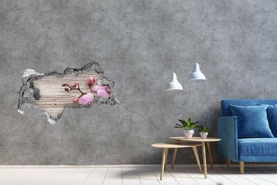 Hole in the wall sticker Orchid flowers on a wooden background