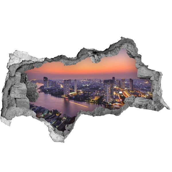 Hole wall sticker View of the city at sunset