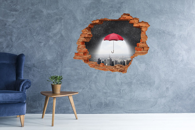 Hole in the wall sticker Red umbrella in the urban landscape