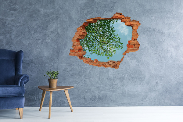 Hole wall sticker Green leaves under a blue sky