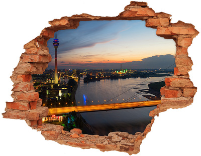 Hole in the wall sticker View of the city at sunset