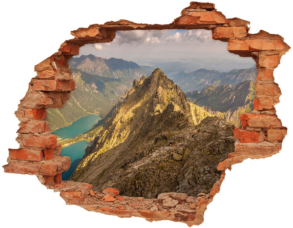Hole wall sticker Mountain landscape through a hole in the wall