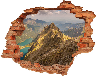 Hole wall sticker Mountain landscape through a hole in the wall