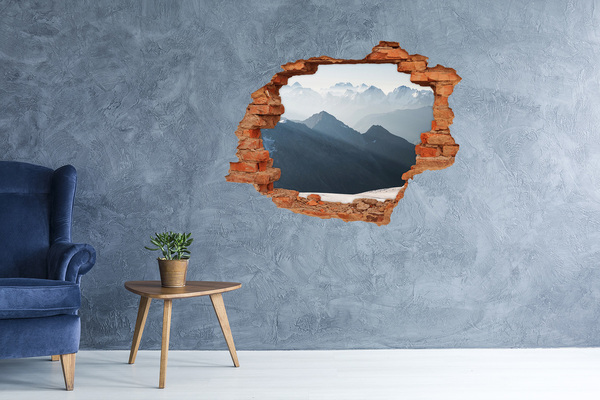 Hole wall sticker Mountain landscape through a hole in the wall