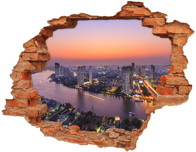 Hole wall sticker View of the city at sunset