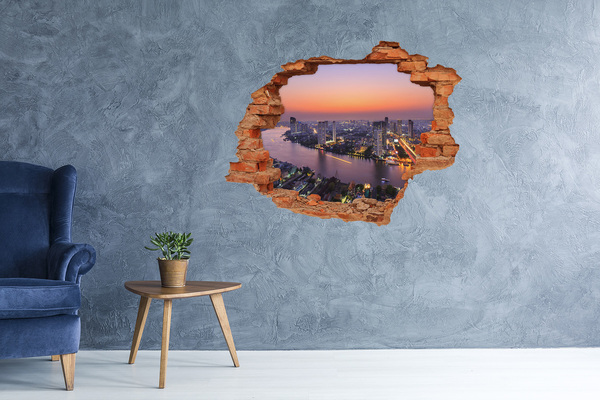 Hole wall sticker View of the city at sunset